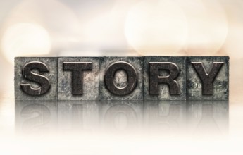 The word STORY written in vintage ink stained letterpress type