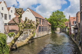 Boat full of tourist enjoying a beautiful canal in Bruges Belgium
