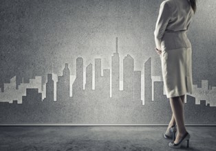 Bottom view of businesswoman and sketches of construction project on wall