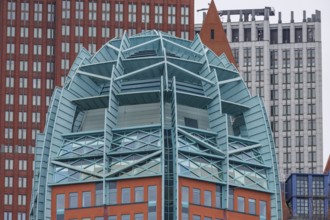 Detailed view of a modern building with a striking architectural design of glass and steel, den