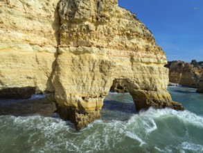 Aerial view on rock cliffs and waves near Praia da Marinha in the Algarve, Portugal, Europe