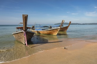 Tropical islands view with long tail boat ocean blue sea water and white sand beach, Krabi Thailand