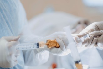 Close-up of a syringe handled by healthcare professionals, showcasing precision in a procedure