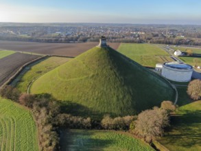 Aerial view of The Lion's Mound with farm land around. The immense Butte Du Lion on the battlefield