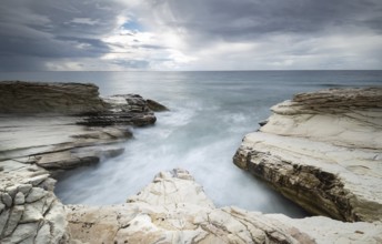 Beautiful Rocky coast with white limestones forming wonderful patterns and waves hitting the rocks.