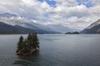 The picturesque little island in the mountain lake. A quiet autumn day in the Swiss Alps