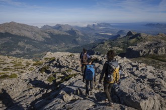 Hikers descending the Puig Tomir towards Fartaritx, Majorca, Balearic Islands, Spain, Europe