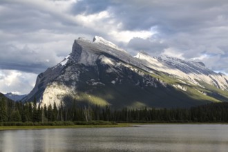 Well-known mountain by the sea rises strikingly into the cloudy sky