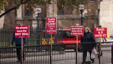 Protesters holding signs and banners in the street, focusing on Brexit issues in the Greater London