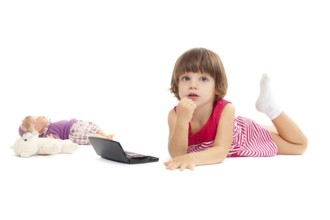Little beautiful girl is playing with make-up over white background
