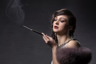 Retro portrait of a woman. A beautiful woman in the style of the 20s and 30s with a cigarette