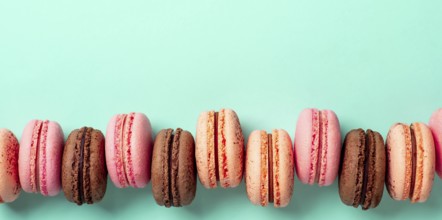 Macarons banner with copy space. Colorful french macarons or macaroons on blue turquoise background