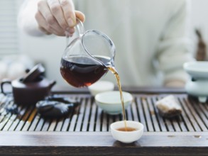 Chinese tea ceremony. Master pouring puer tea in cups. Pu erh tea ceremony
