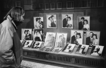 05/03/1983 GDR district of Cottbus town of Spremberg. Young woman looks into the shop window of the
