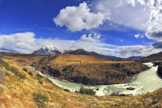 Travel to Chile. The river bends a horseshoe under the flying clouds. The picture was taken Fisheye