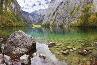 Magic reflection in German lake Koenigssee. Cloudy day on the lake. Clouds and mountains reflected