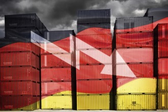 Stacked containers in German national colours with downward pointing arrow, symbolic photo economic