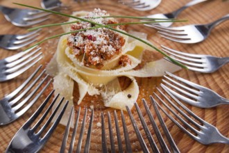 Presentation first dish of pappardelle with meat sauce and tomato
