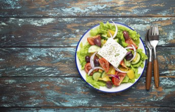 Traditional Greek Salad with Feta Cheese, Tomatoes, Bell Pepper, Cucumbers, Olives, Herbs in white
