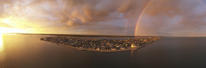 Rain falls as sun shines in the middle of the night at Kotzebue Alaska creating a beautiful