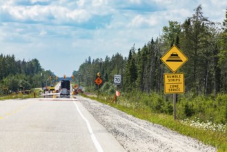Temporary condition road warning signs on the roadside before road work zone, rumble strips on a