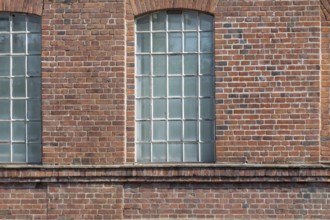 Three large mullioned windows in a uniform brick wall, Bottrop, North Rhine-Westphalia, Germany,