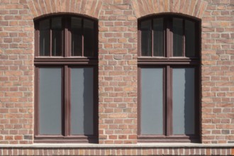 Two symmetrically arranged windows in a brick façade, Bottrop, North Rhine-Westphalia, Germany,