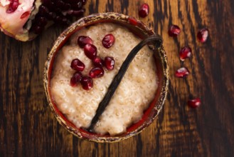 A bowl of tapioca pudding with vanilla and pomegranate