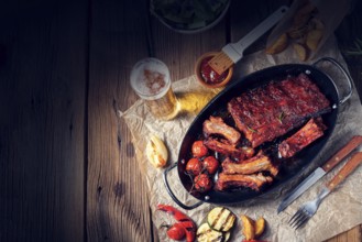 Grilled ribs in a spicy marinade with salad and vegetables