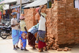 Kanchipuram, Tamil Nadu, South India, India, Asia, Group of labourers stacking bricks on the
