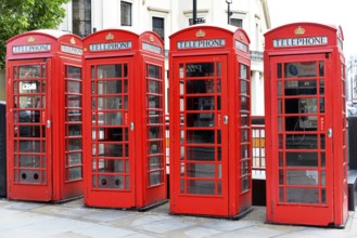 Europe, Several red telephone boxes on a city street, London, London region, England, United