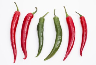 Image shows red and green chilli pepper in a row