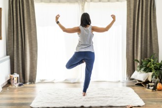 Rear view of a dedicated woman engaging in yoga and performing mudras gracefully