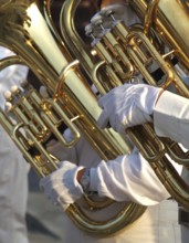 Partial view of two tubas that are part of a brass band