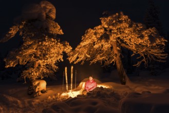 Man around a campfire, Norrbotten, Lapland, Sweden, February 2016, Europe