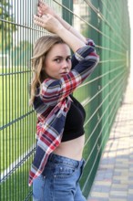 Portrait of young millennial woman on street. Hippie lifestyle. Happy smiling woman. Outdoors.