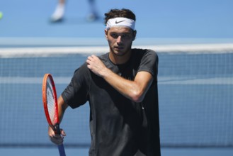 MELBOURNE, AUSTRALIA, JANUARY 12: Taylor Fritz of USA feels the heat whilst practicing with Daniil