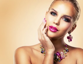 Beautiful woman with dark makeup and pink lipstick posing on beige background wearing flower spring