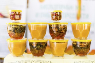 Honey with dried fruits and dried nuts - walnuts, hazelnuts, peanuts, almonds, cashews, plums,