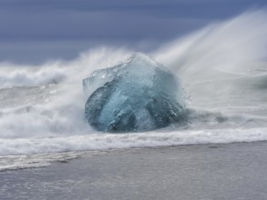 Diamond Beach, iceberg in the surf, near Jökulsarlon glacier lagoon, Vatnajökull National Park,