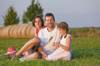 Family on a summer meadow, Altdöbern, Brandenburg, Germany, Europe