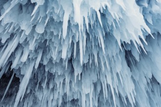 Ice cave on Baikal lake in winter. Blue ice and icicles in grotto. Olkhon island, Baikal, Siberia