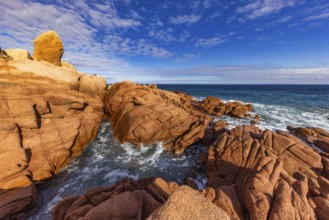 Coastal landscape with red rocks and surf in blue sky and sunshine, Spiaggia di Cala E'Luas,