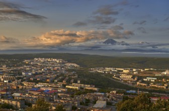 Petropavlovsk-Kamchatsky city at sunset and cone of Koryak volcano. Kamchatka Peninsula, Russia,