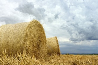 Straw bales on farmland Storm clouds