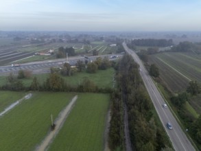 Aerial view of a highway crossing the italian countryside after heavy rain, with flooded fields and