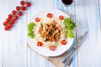 Turkey fricassee on rice with asparagus and peppers