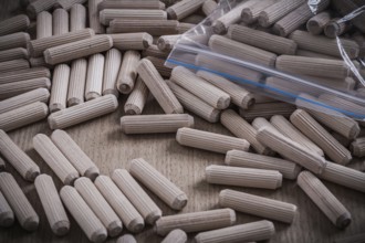 Composition of wooden dowels on wood board construction concept
