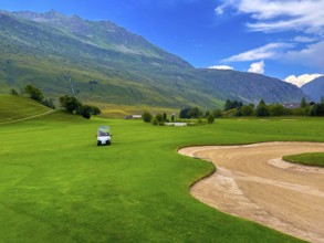 Beautiful Modern Luxury Golf Cart on Golf Course with Sand Trap and with Mountain View in the Swiss
