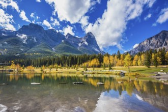 Shallow lakes surrounded by forests and mountains. Shining day in Canmore, Canadian Rockies.